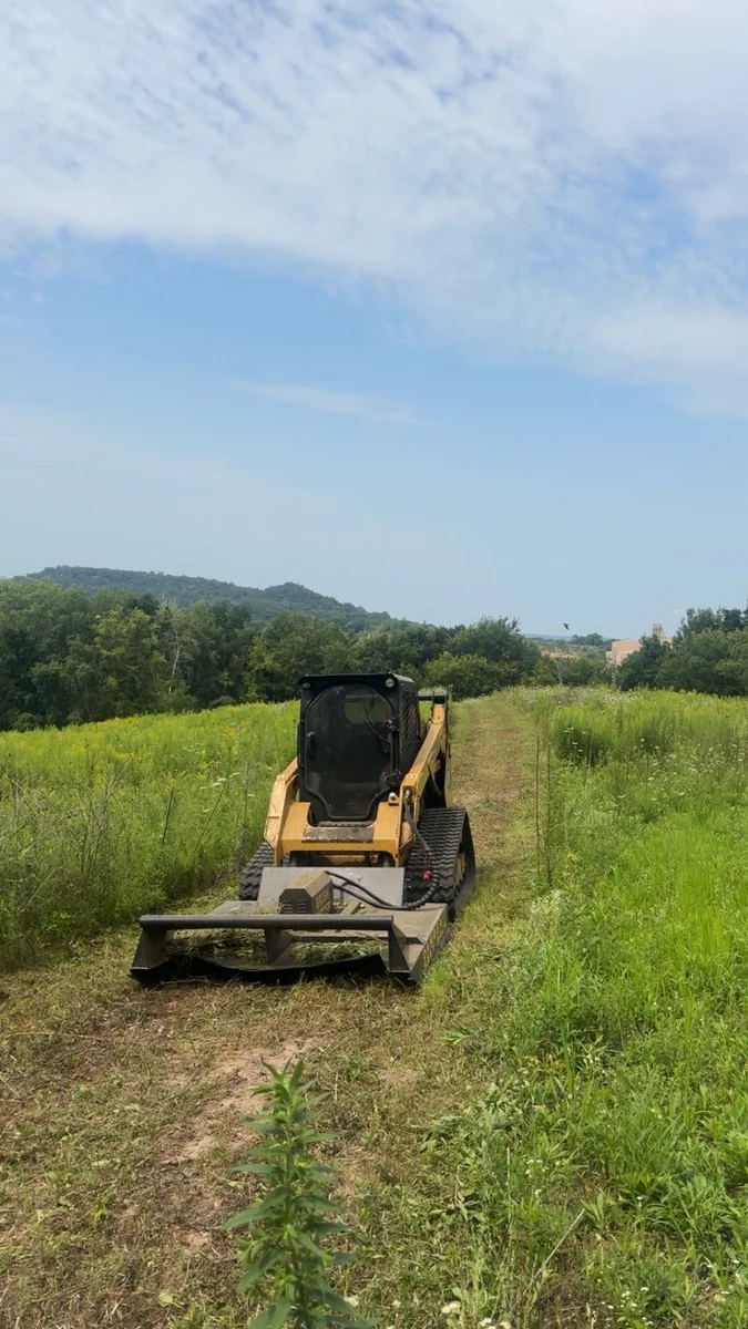 A cleared path through a grassy field.